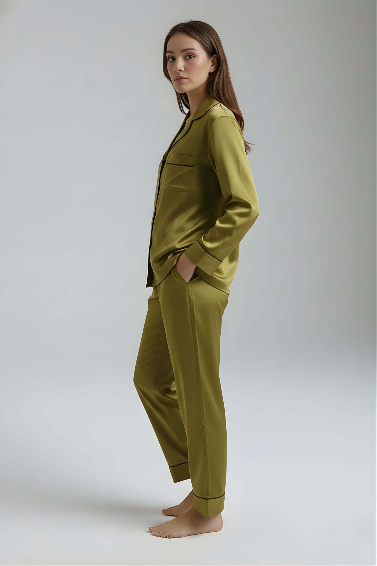 Side profile of woman in Koye Deep Oleev satin lounge set showing side pockets and collar detail. #color_Deep Olive