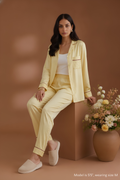cover of Koye Pause Pajama Set in butter yellow satin with button-down shirt. #color_Butter Yellow
