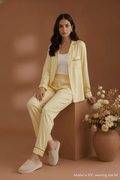 cover of Koye Pause Pajama Set in butter yellow satin with button-down shirt. #color_Butter Yellow