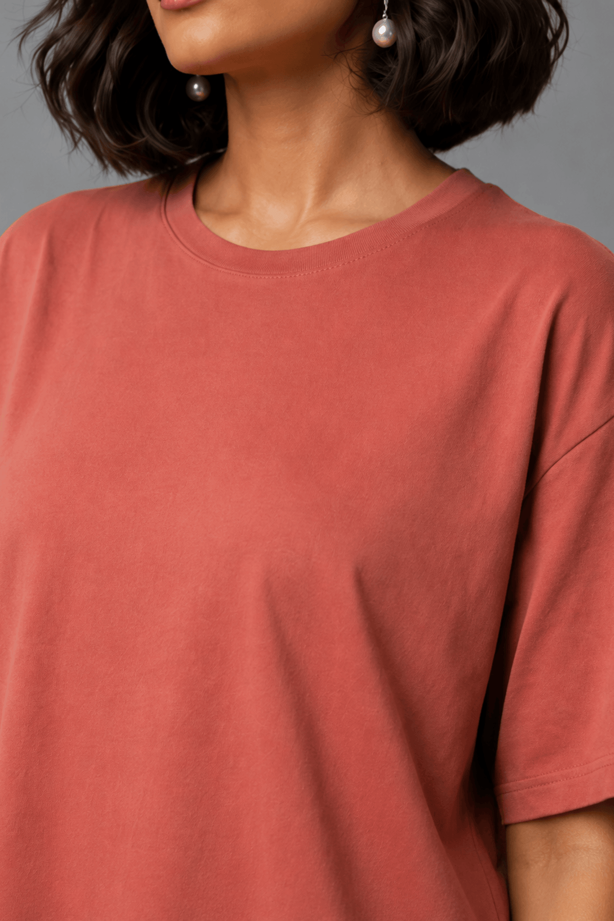 Close-up detail of the smooth, structured bamboo-cotton fabric and neckline on the back of the Snug Oversized Dress. #color_Coral