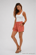 Woman smiling in a relaxed fit rosewood Bamboo-Hemp Play. #color_Rosewood