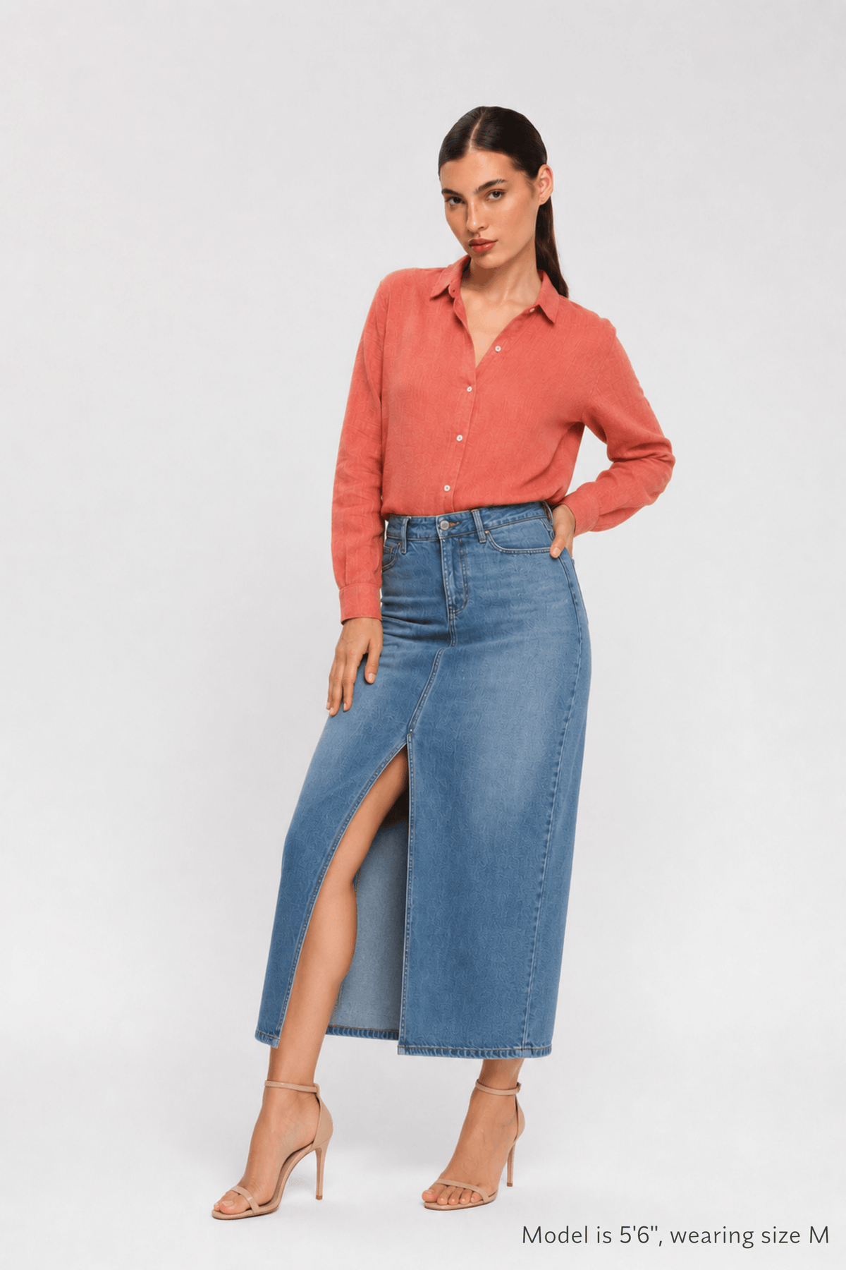 Woman sitting on a chair wearing a pink shirt and shorts by Koye in Rosewood pink bamboo-hemp. #color_Rosewood