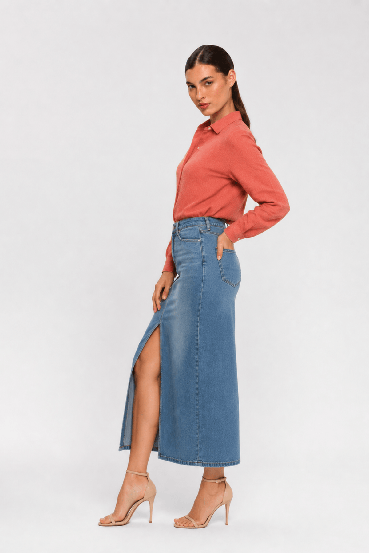 side pose of Woman sitting on a chair wearing a pink shirt and shorts by Koye in Rosewood pink bamboo-hemp. #color_Rosewood