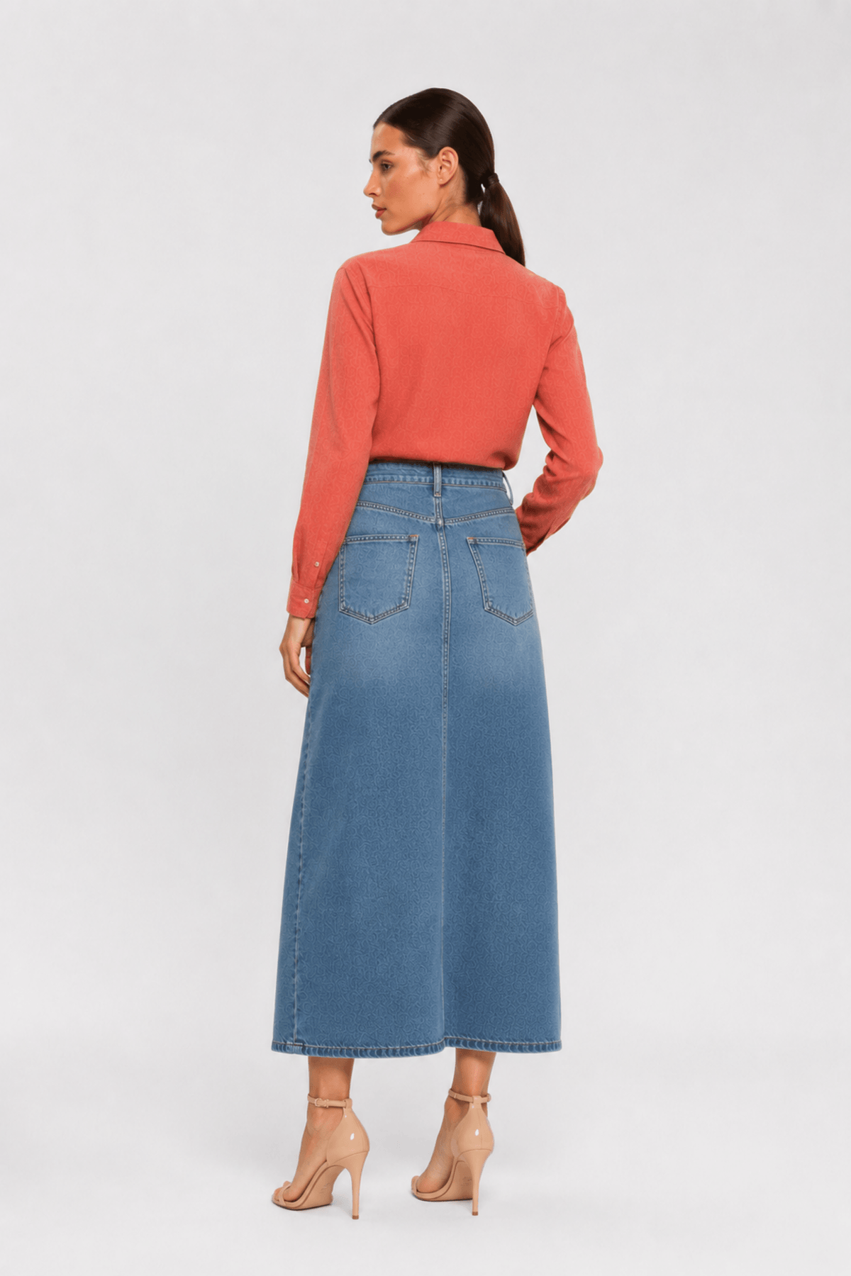 back of Woman sitting wearing a pink shirt and shorts by Koye in Rosewood pink bamboo-hemp. #color_Rosewood