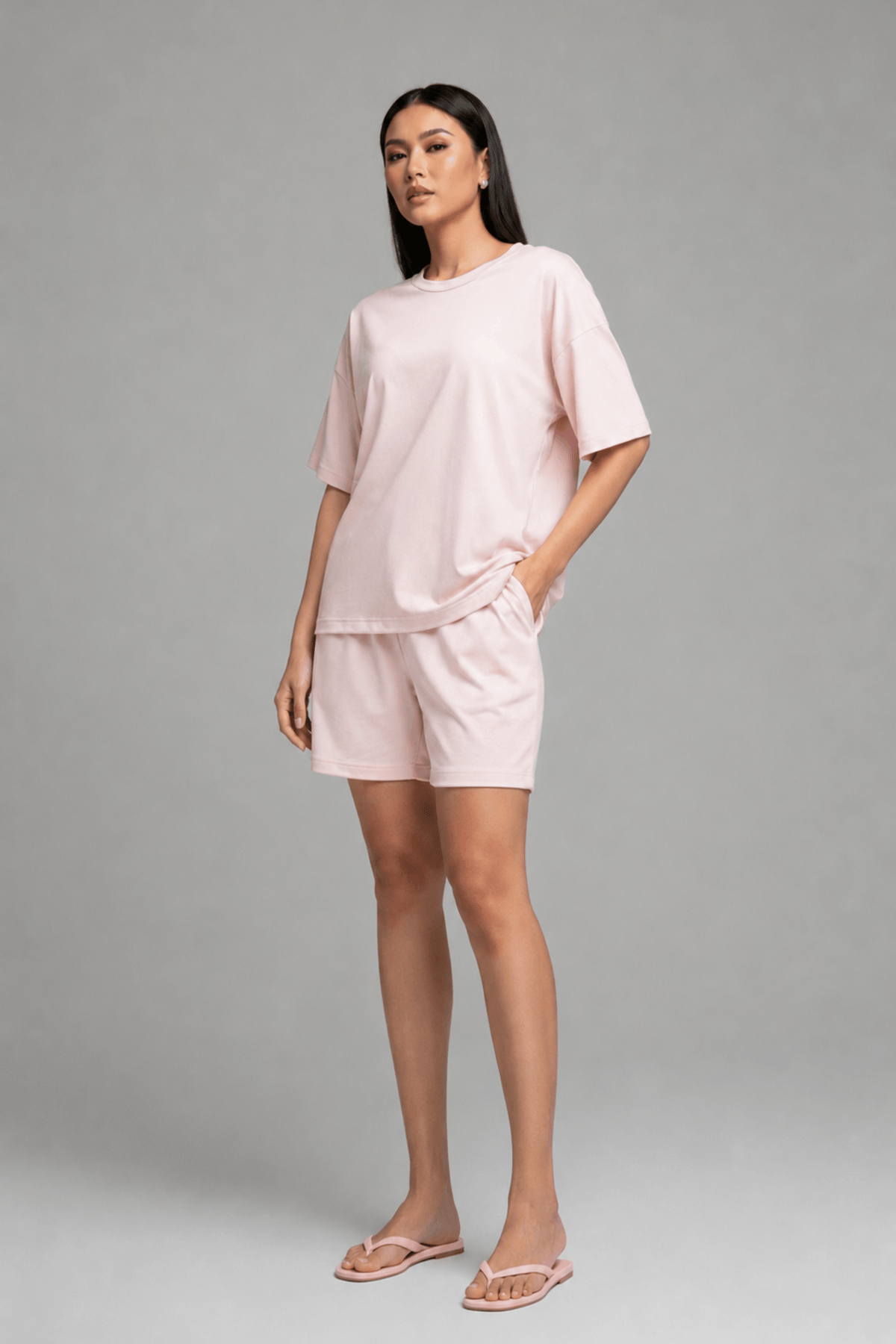 Side profile of model smiling in Koye Chilled Out bamboo-cotton shorts set in soft pink. #color_Blush Pink