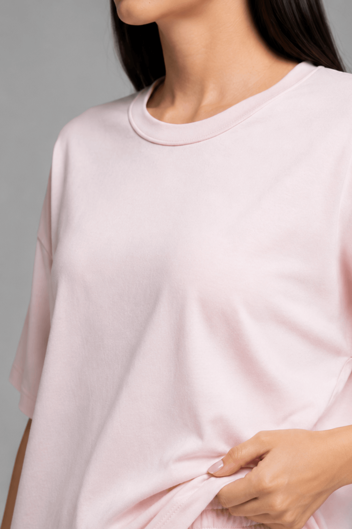 Close up detail of pink bamboo-cotton fabric texture and side slit on Koye loungewear top. #color_Blush Pink