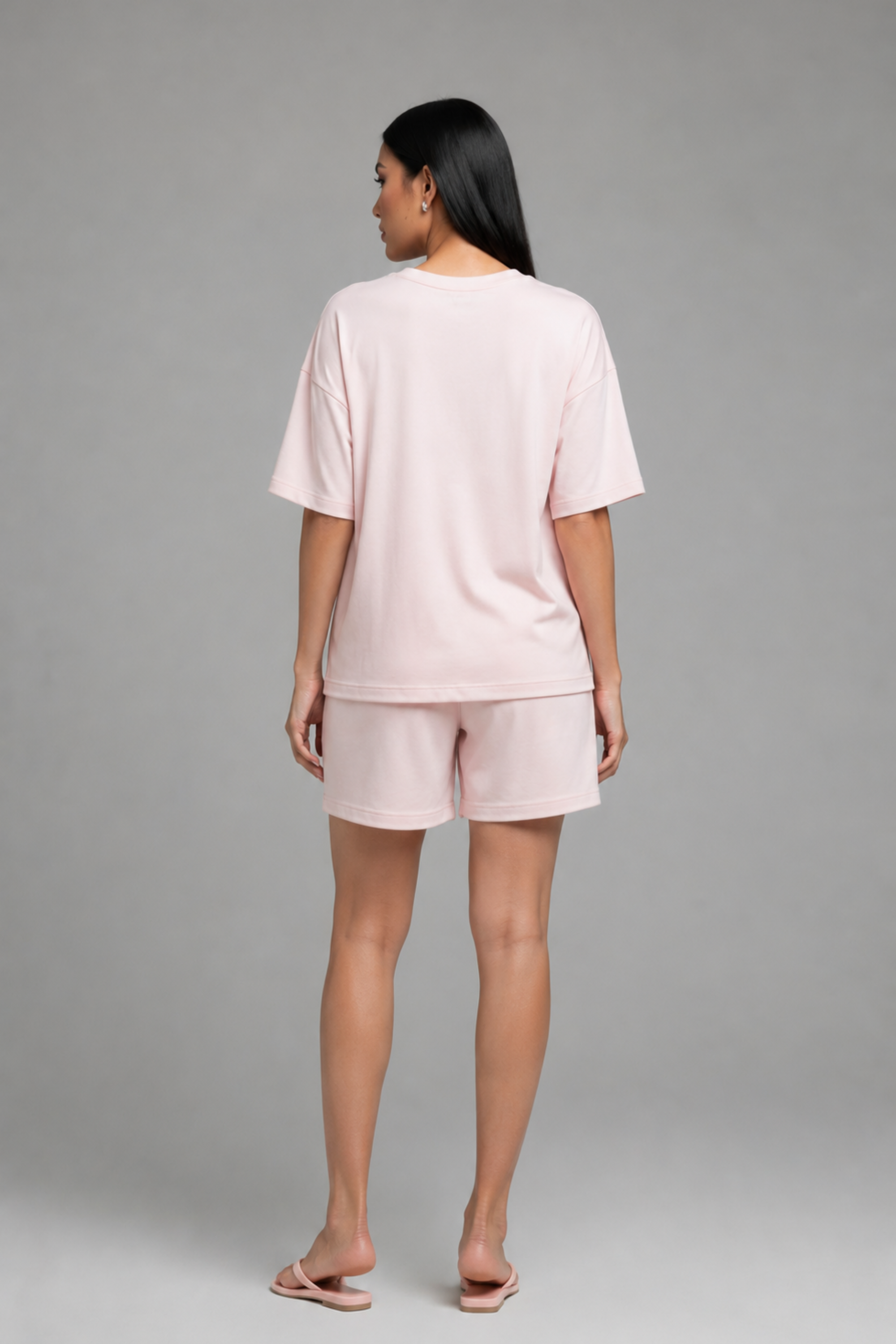 Back view of Koye pink oversized t-shirt and shorts loungewear set. #color_Blush Pink