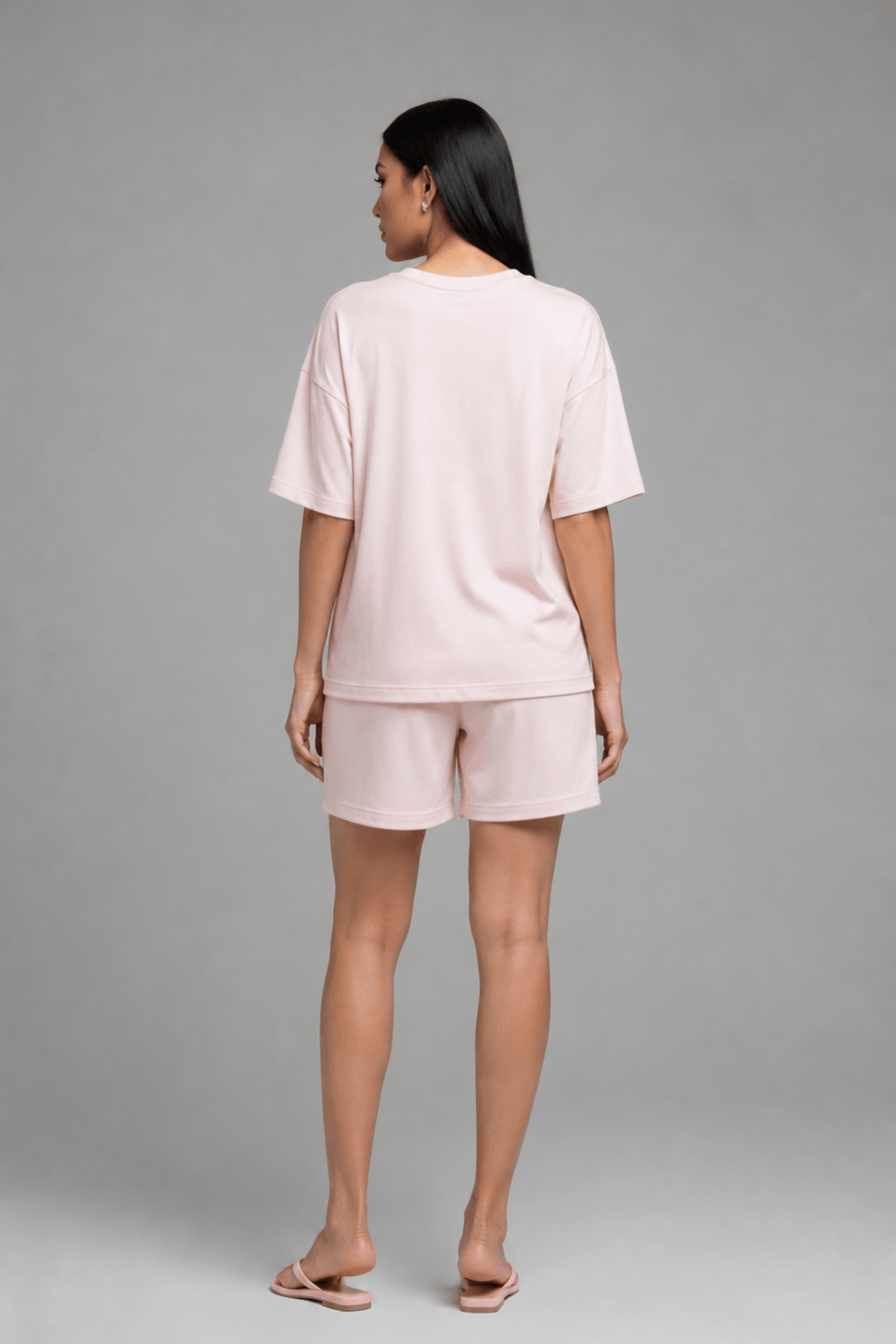 Back view of Koye pink oversized t-shirt and shorts loungewear set. #color_Blush Pink