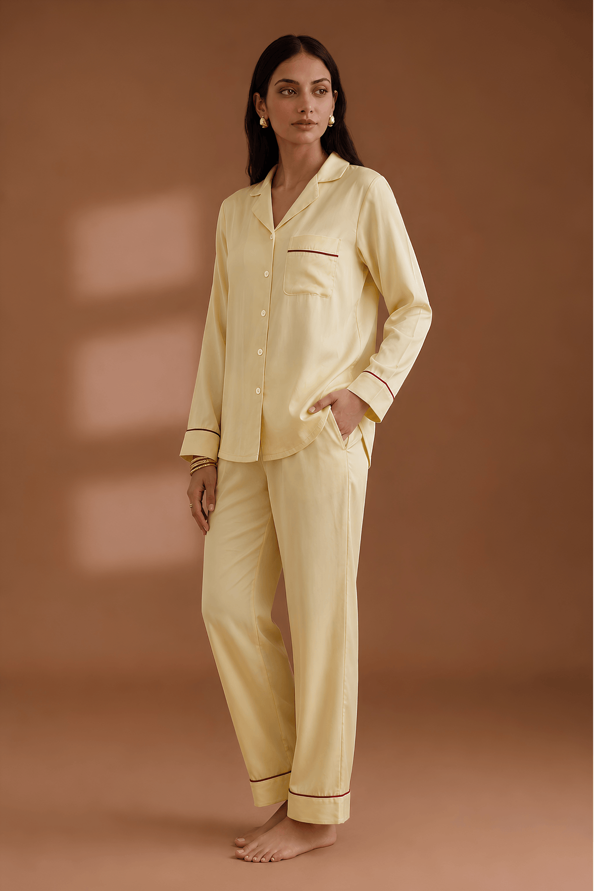 Side profile of woman in Koye satin lounge set showing side pockets and collar detail. #color_Butter Yellow