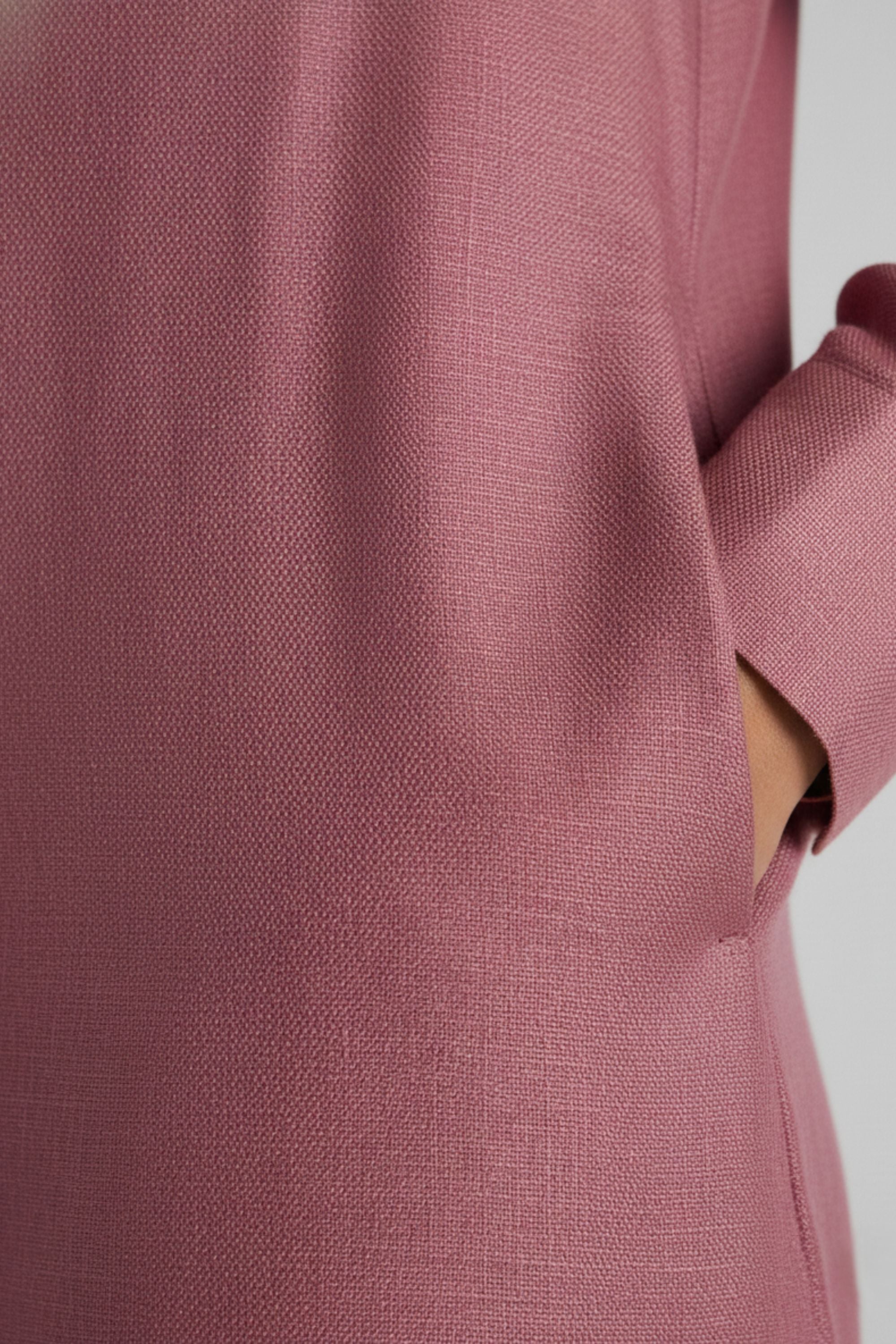 Close-up texture of Rosewood pink bamboo-hemp fabric and pocket detail on Koye sleepwear. #color_Rosewood