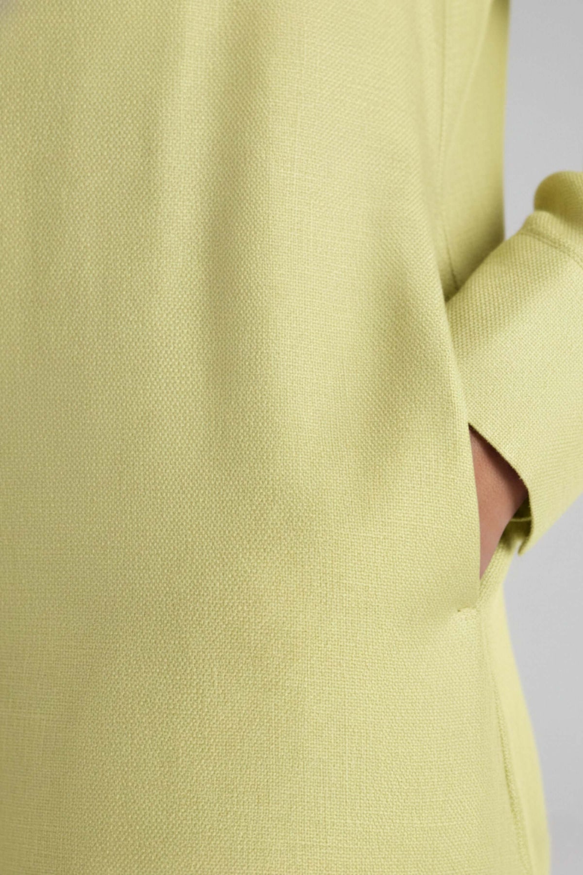 Detail shot of yellow fabric texture and side pocket on Koye Breeze Shirt Dress. #color_Sunshine Yellow