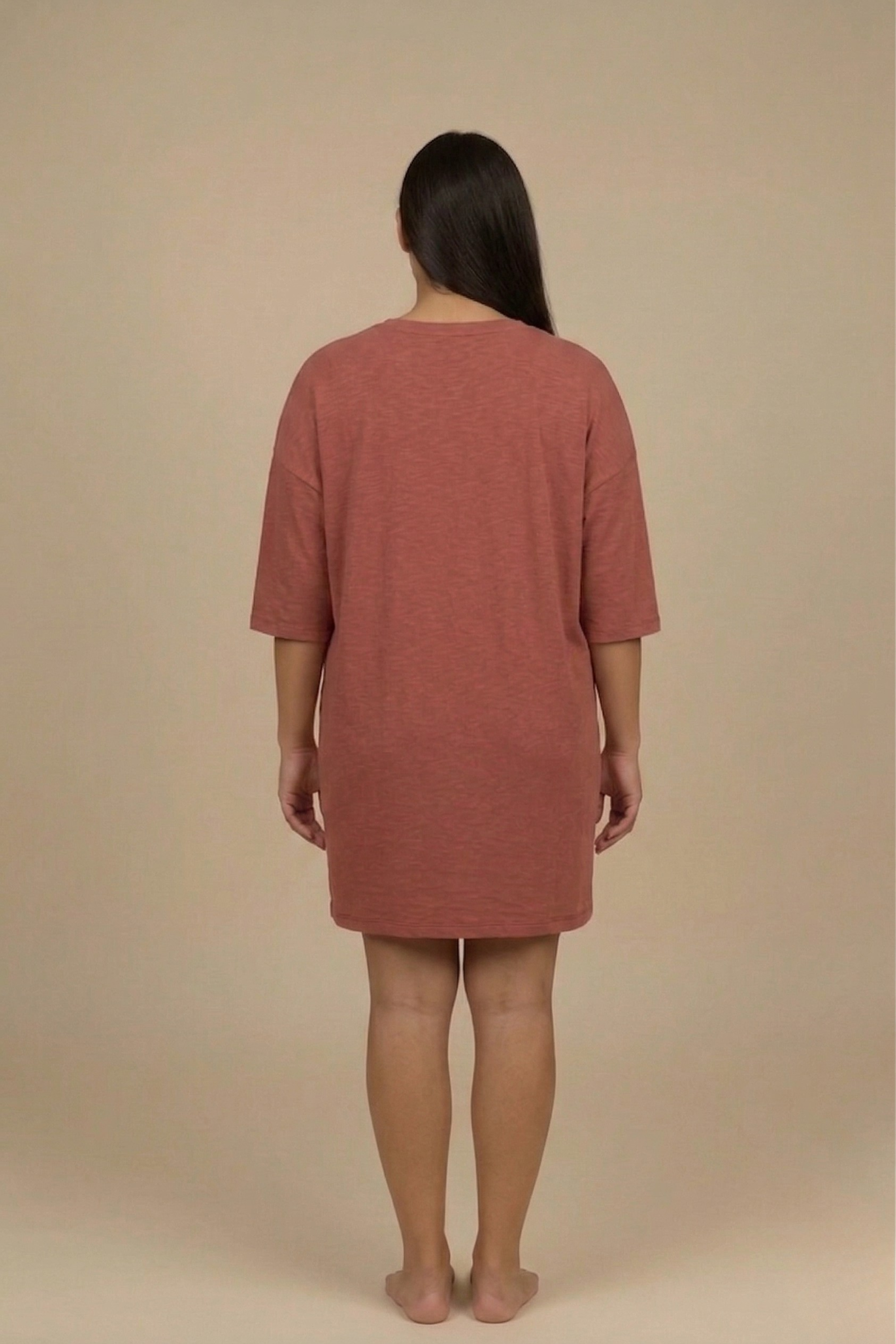 Back view of the Dusky Mauve Snug Oversized Dress, showcasing the relaxed, flowy fit that falls beautifully above the knee. #color_Coral