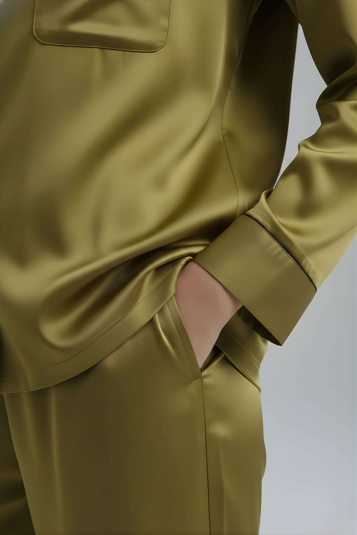 Close-up of pocket detail and sleeve cuff on Koye Deep Oleev satin pajama top. #color_Deep Olive