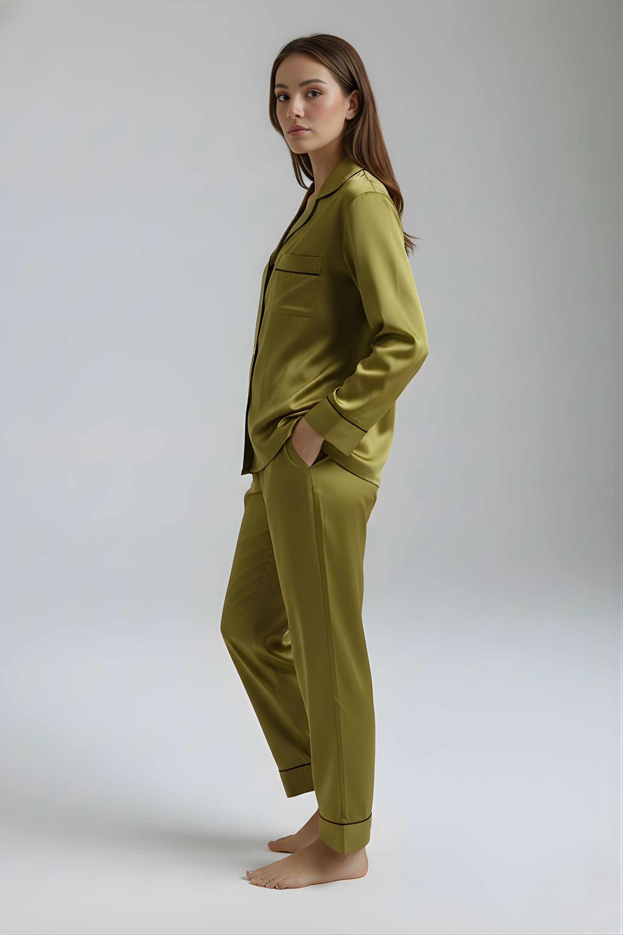 Side profile of woman in Koye Deep Oleev satin lounge set showing side pockets and collar detail. #color_Deep Olive
