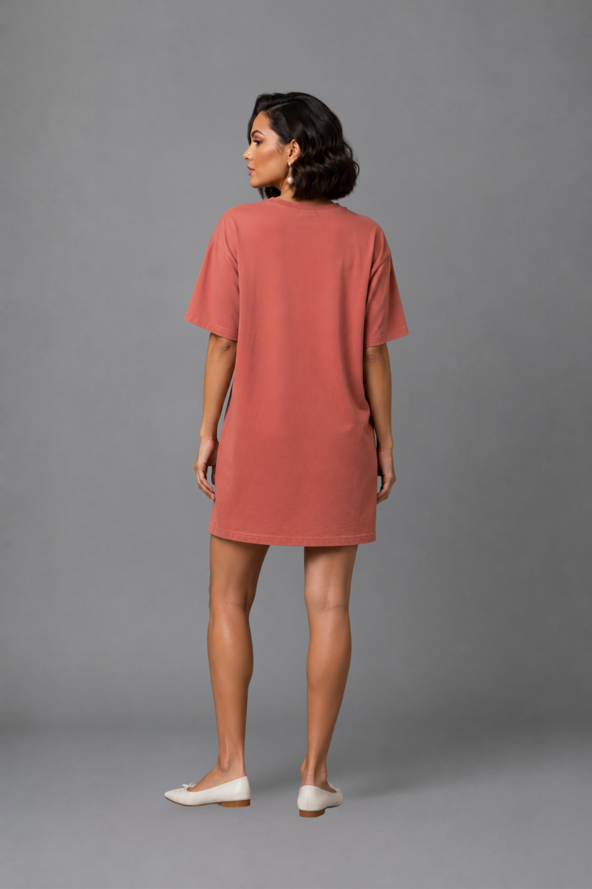 Back view of the Dusky Mauve Snug Oversized Dress, showcasing the relaxed, flowy fit that falls beautifully above the knee. #color_Coral