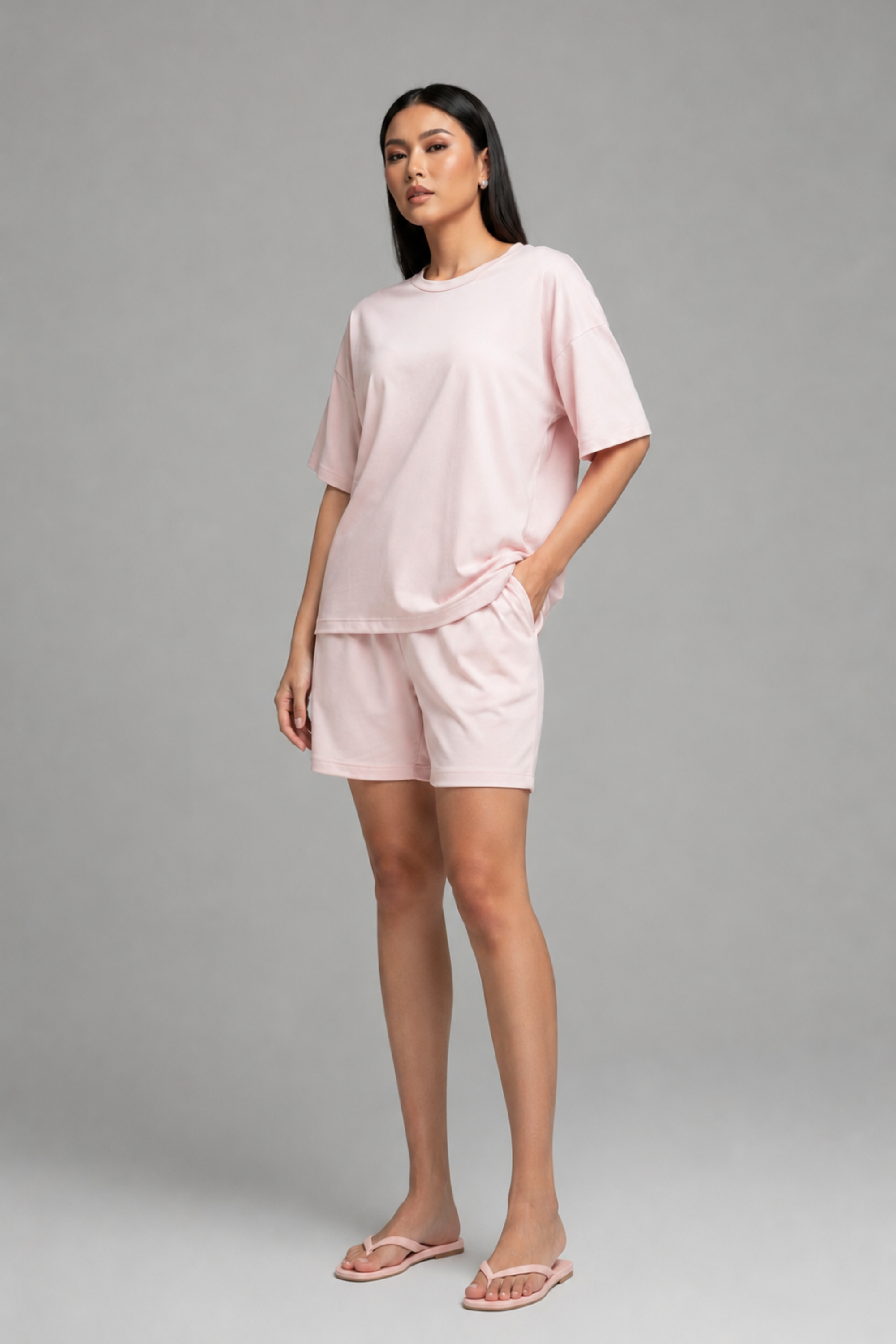 Side profile of model smiling in Koye Chilled Out bamboo-cotton shorts set in soft pink. #color_Blush Pink