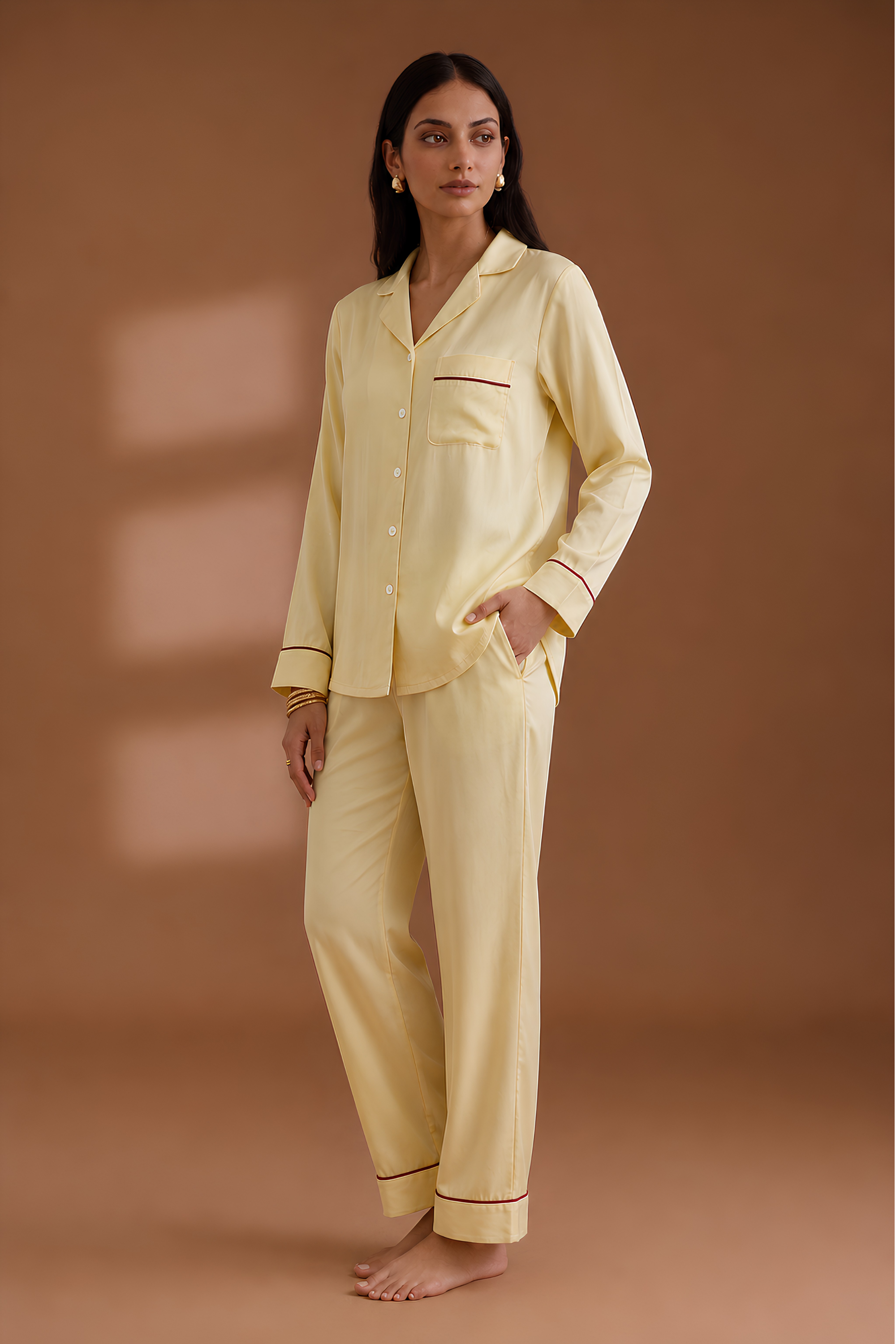 Side profile of woman in Koye satin lounge set showing side pockets and collar detail.  #color_Butter Yellow