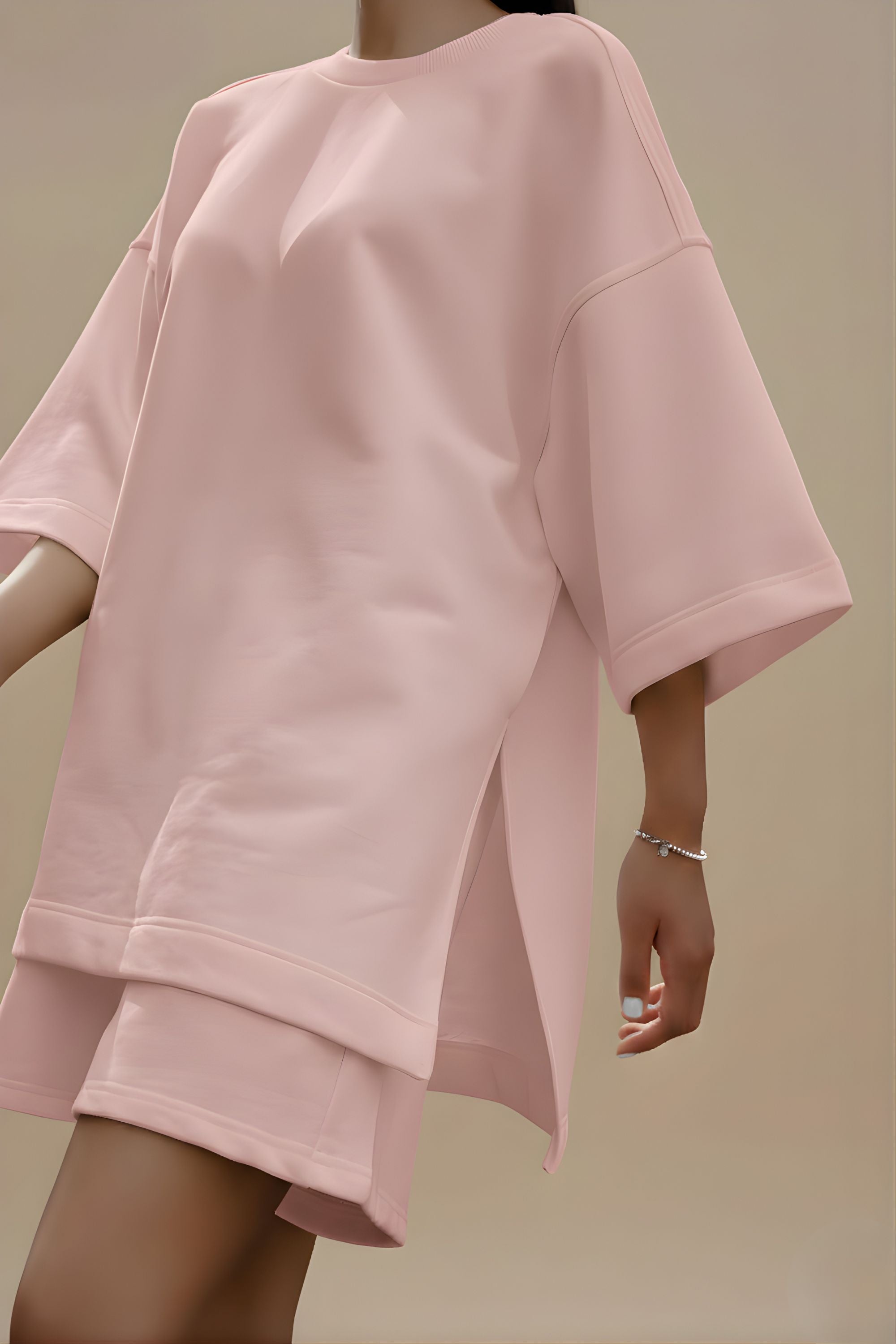 Close up detail of pink bamboo-cotton fabric texture and side slit on Koye loungewear top. #color_Blush Pink