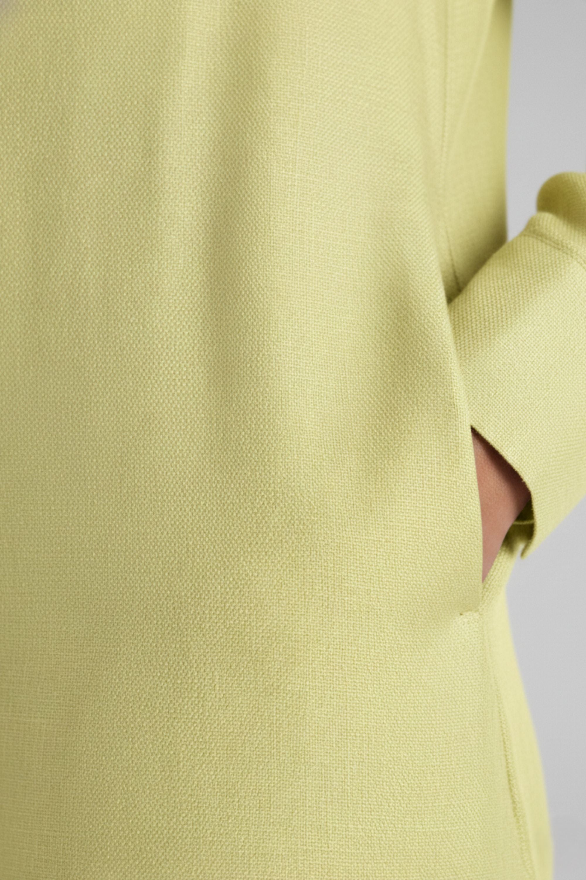 Detail shot of yellow fabric texture and side pocket on Koye Breeze Shirt Dress. #color_Sunshine Yellow