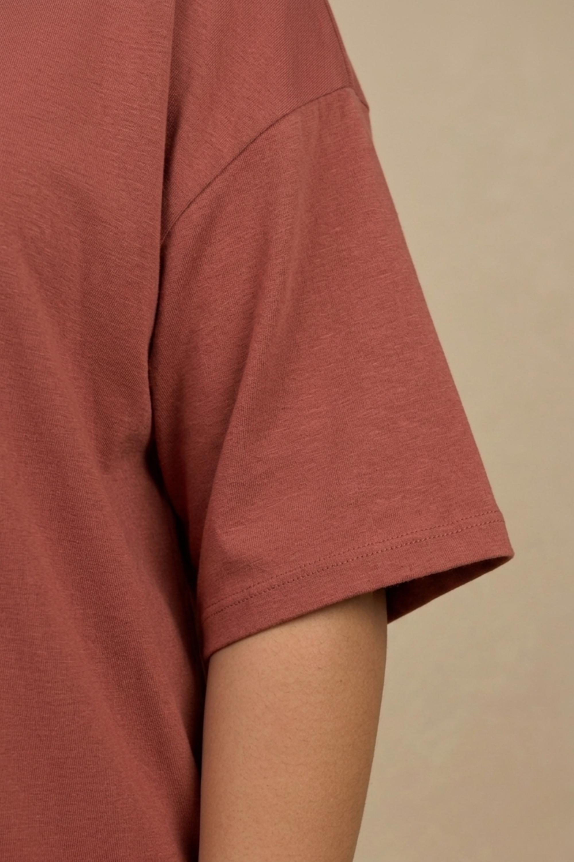 Close-up detail of the smooth, structured bamboo-cotton fabric and neckline on the back of the Snug Oversized Dress. #color_Coral