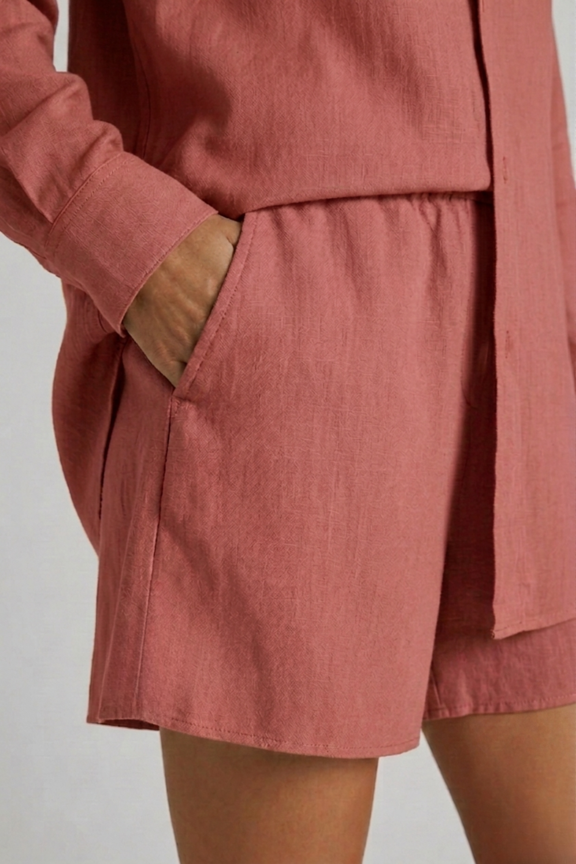 Close-up detail of the side pocket and soft drape on the Bamboo-Hemp Play Short. #color_Rosewood
